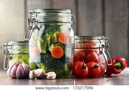 Jars With Marinated Food And Organic Raw Vegetables