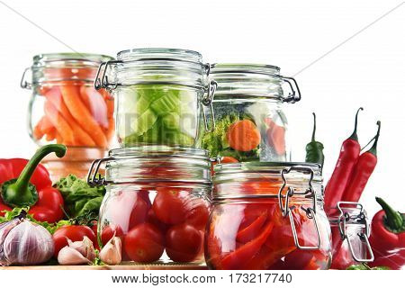 Jars With Marinated Food And Raw Vegetables Isolated On White