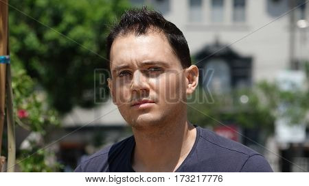 A Serious Man Gazing In Urban Park