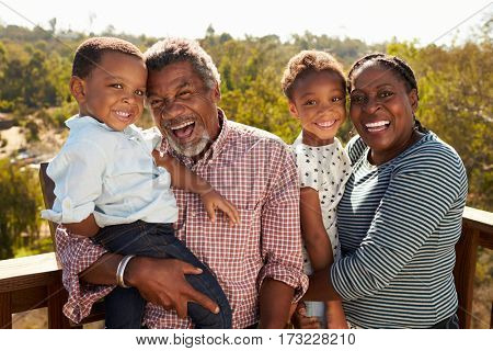 Grandparents And Grandchildren Standing On Observation Deck