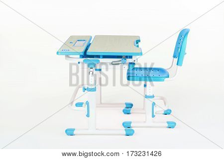 Blue chair and school table on the white isolated background.