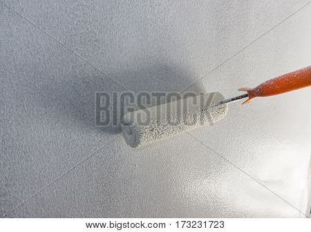 Panting white color on paster wall with paddle roller