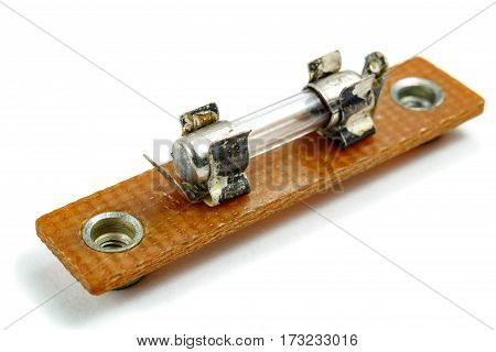 Vintage electric fuse mounted in holder on a white background