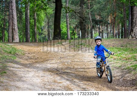 Happy Cute Blond Kid Boy Having Fun His First Bike On Sunny Summ