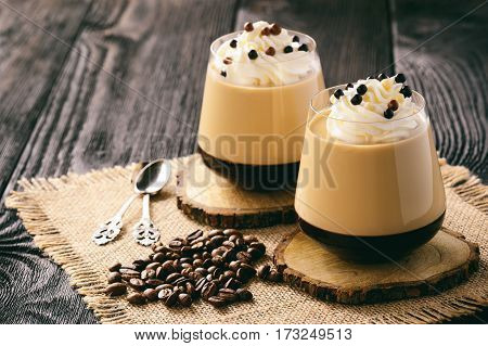 Coffee pannacotta in glasses on black background.