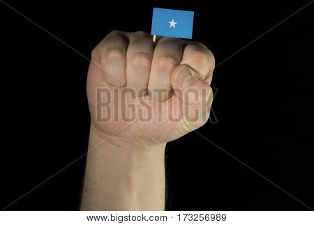 Man Hand Fist With Somalian Flag Isolated On Black Background