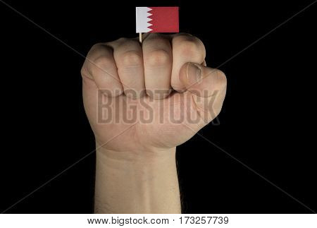 Man Hand Fist With Bahraini Flag Isolated On Black Background