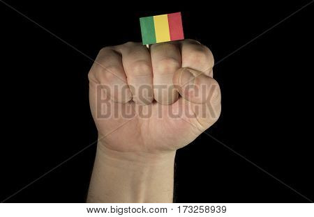 Man Hand Fist With Malian Flag Isolated On Black Background