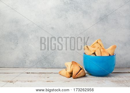 Purim celebration concept with hamantaschen cookies on wooden table