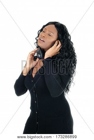 A young African American woman listening with her headphones to music with her eyes closed isolated for white background.