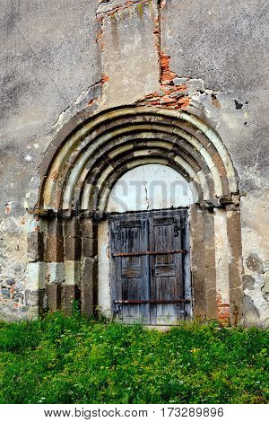 Gate of the fortified medieval saxon church Ungra, Transylvania, Romania.