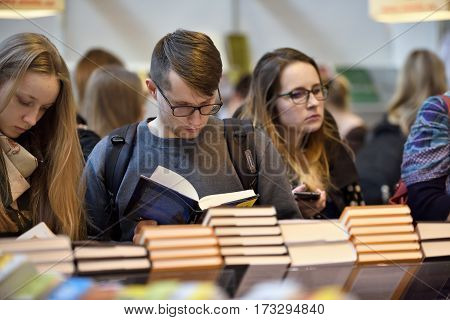 VILNIUS - FEBRUARY 25: Many people choose books at the indoor book market on February 25 2017 in Vilnius Lithuania. Vilnius is the capital of Lithuania and its largest city.