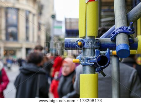 Magdalen street Oxford United Kingdom February 19 2017: Scaffolding with closeup on bolts clamped joints and foam safety protection for pedestrians in Oxford England