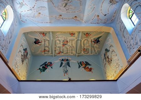 DEIR RAFAT ISRAEL - FEBRUARY 17 2017: Ceiling and rood-loft painting in the church in the monastery of Dir Rafat with the inscription Ave Maria in 323 languages