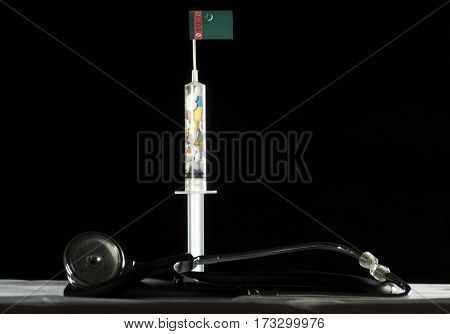 Stethoscope And Syringe Filled With Drugs Injecting The Turkmenistani Flag On A Black Background