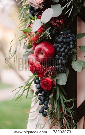 Autumnal Wedding Composition Of Roses, Apples, Grape And Pomergranate, In Red Colour, Closeup