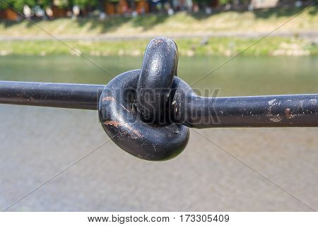 Metal handrail folded in a knot closeup. Architecture