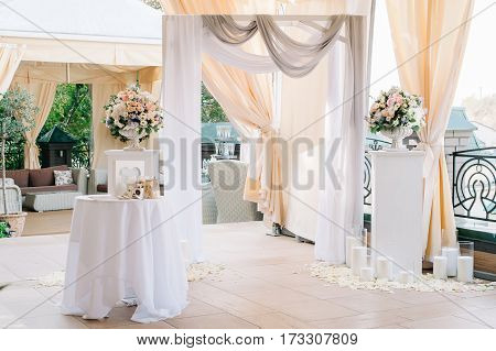 Arch For The Wedding Ceremony, Decorated With Cloth, Flowers And Greenery, In Big Hall