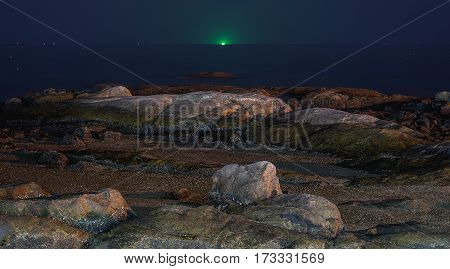 Rocks at seaside with twilight blue sky.
