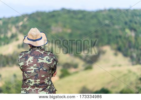 Soldier or Forest officials looking at moutain in the big forest with day light.