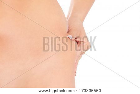 Slim woman pinch skin on hip