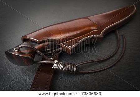handmade knife Damascus of mosaic with a mammoth tusk on a black background
