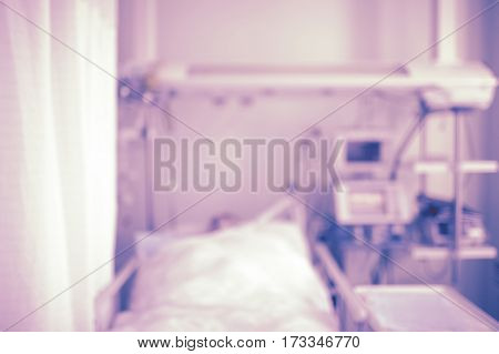 Patient bed in intensive care unit unfocused background.