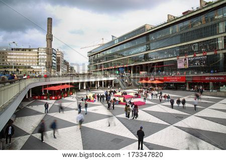 STOCKHOLM SWEDEN - AUGUST 19 2016: Pedestrian walk on Sergels Torg with the glass obelisk Kristallvertikalaccent It is central public square in the city in Stockholm Sweden on August 19 2016.