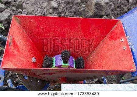 empty seed hopper hand seeder in agriculture field