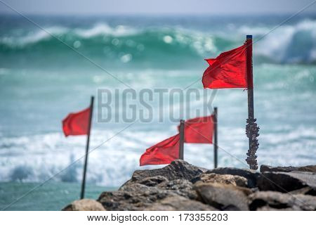 Red warning flag on beach showing that swimming is dangerous or prohibited