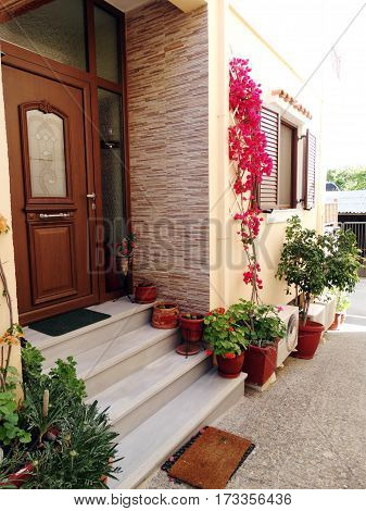 door architecture detail in house building with bougainvillea Greece
