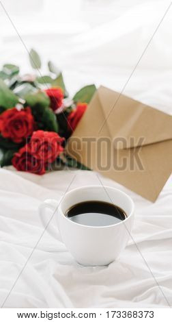 a bouquet of red roses coffee card with congratulations supply in bed