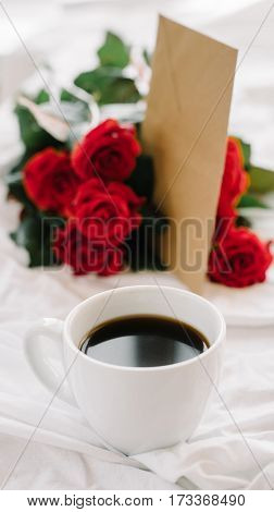 a bouquet of red roses coffee card with congratulations supply in bed