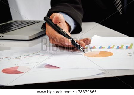 Business Man Hand Pointing At Business Document During Discussion At Meeting