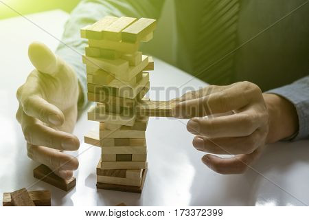 A Male Hand Stopping The Domino Effect. Retro Style Image Executive And Risk Control Concept