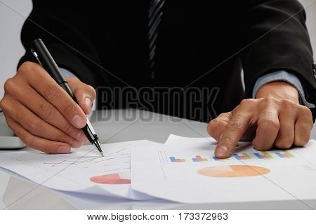 Business Man Hand Pointing At Business Document During Discussion At Meeting