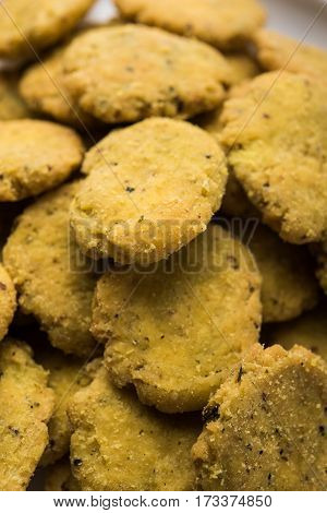 Tasty North Indian snack mathri or mathari served with pickle. Selective focus photograph.