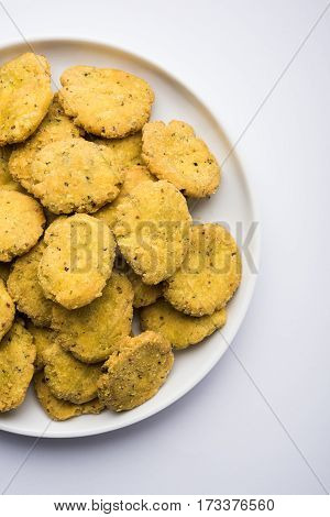 Tasty North Indian snack mathri or mathari served with pickle. Selective focus photograph.