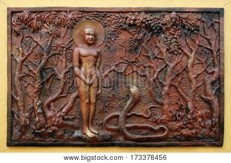 KOLKATA,INDIA - FEBRUARY 12: Love always wins anger and hatred: Bhagavan Mahavira enlightens a deadly poisonous Candkausika, Street bas relief on the wall of Jain Temple in Kolkata on February 12,2016