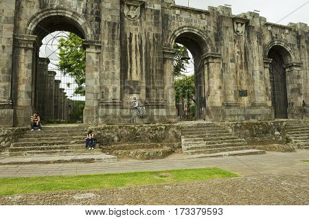 CARTAGO, COSTA RICA - JUNE 17, 2012: Unidentified people sit at the entrance to the ruins of the Santiago Apostol cathedral in Cartago, Costa Rica.