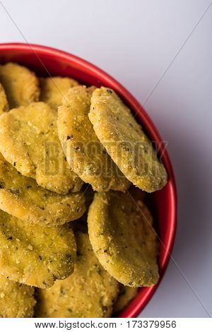Tasty North Indian snack mathri or mathari served with pickle. Selective focus photograph.