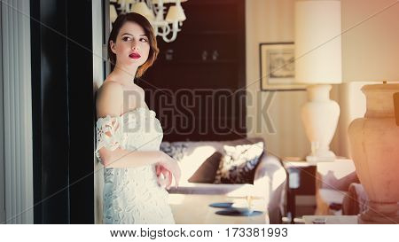 Beautiful Young Woman Standing Near The Door In The Light Luxury Room And Looking Somewhere
