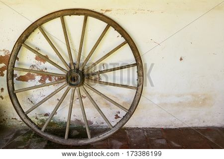 A whell of old wagon on the wall