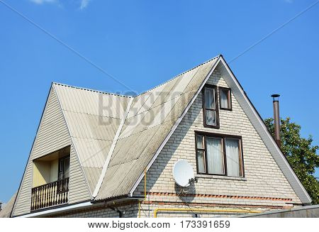Gable and Valley type of roof construction. Building attic white brick house construction with different types of roof designs