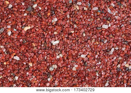 Red stone texture close-up horizontal background. Macro photo.