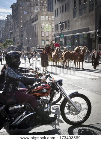 NEW YORK - 11 NOV 2016: Motorcycle riders wait for the Wells Fargo horsedrawn carriage to pass at the annual Americas Parade on 5th Avenue on Veterans Day in Manhattan.