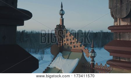 Roof of traditional snow-covered russian cottage - terem in a forest.. Top view 4K