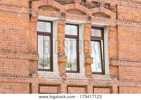 The windows on the red brick building in the daytime