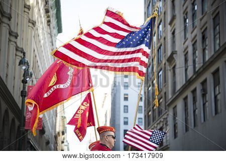 NEW YORK - 11 NOV 2016: American Flag and flag of US Marine Corps, USMC carried by personel marching in Americas Parade up 5th Avenue on Veterans Day in Manhattan.