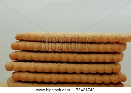 Stacked plain bisuits on a wooden cutting board